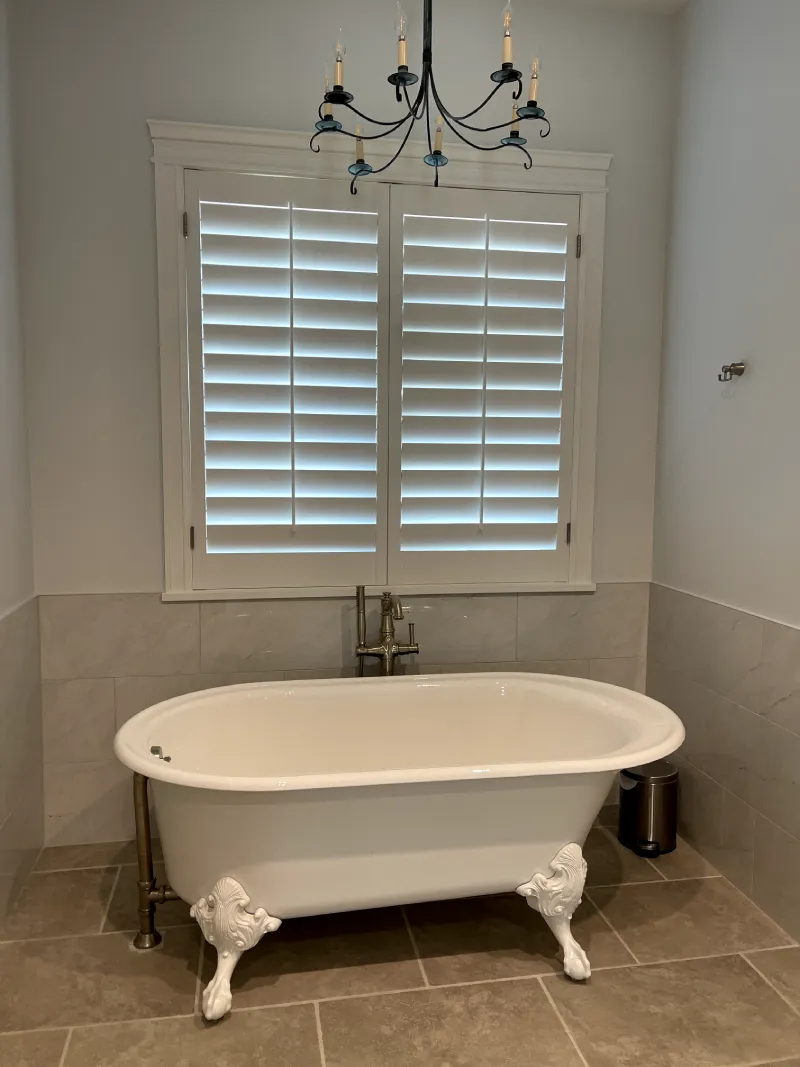 Freestanding tub under shuttered window