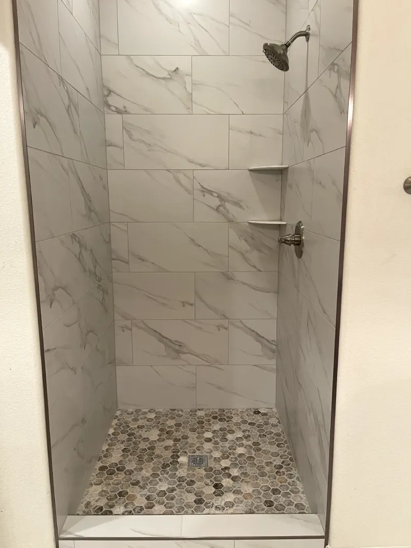 Modern shower with marble wall tiles.