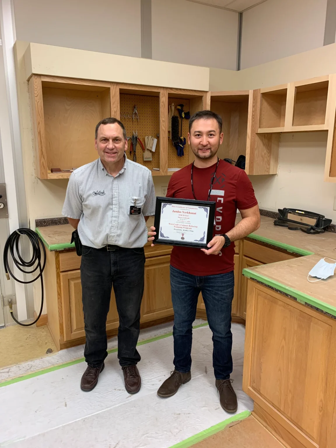 Man holding a certificate in workshop