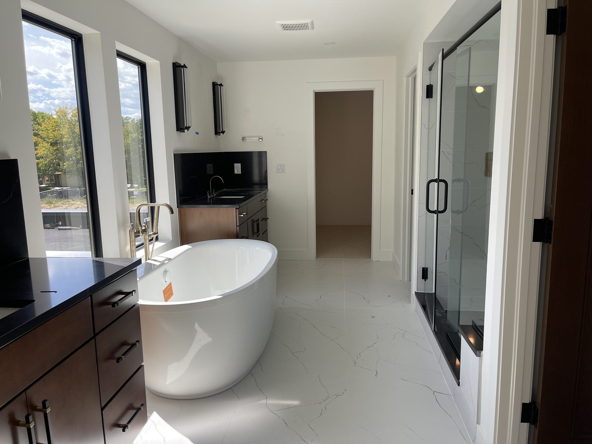 Modern bathroom with a freestanding tub and glass shower.
